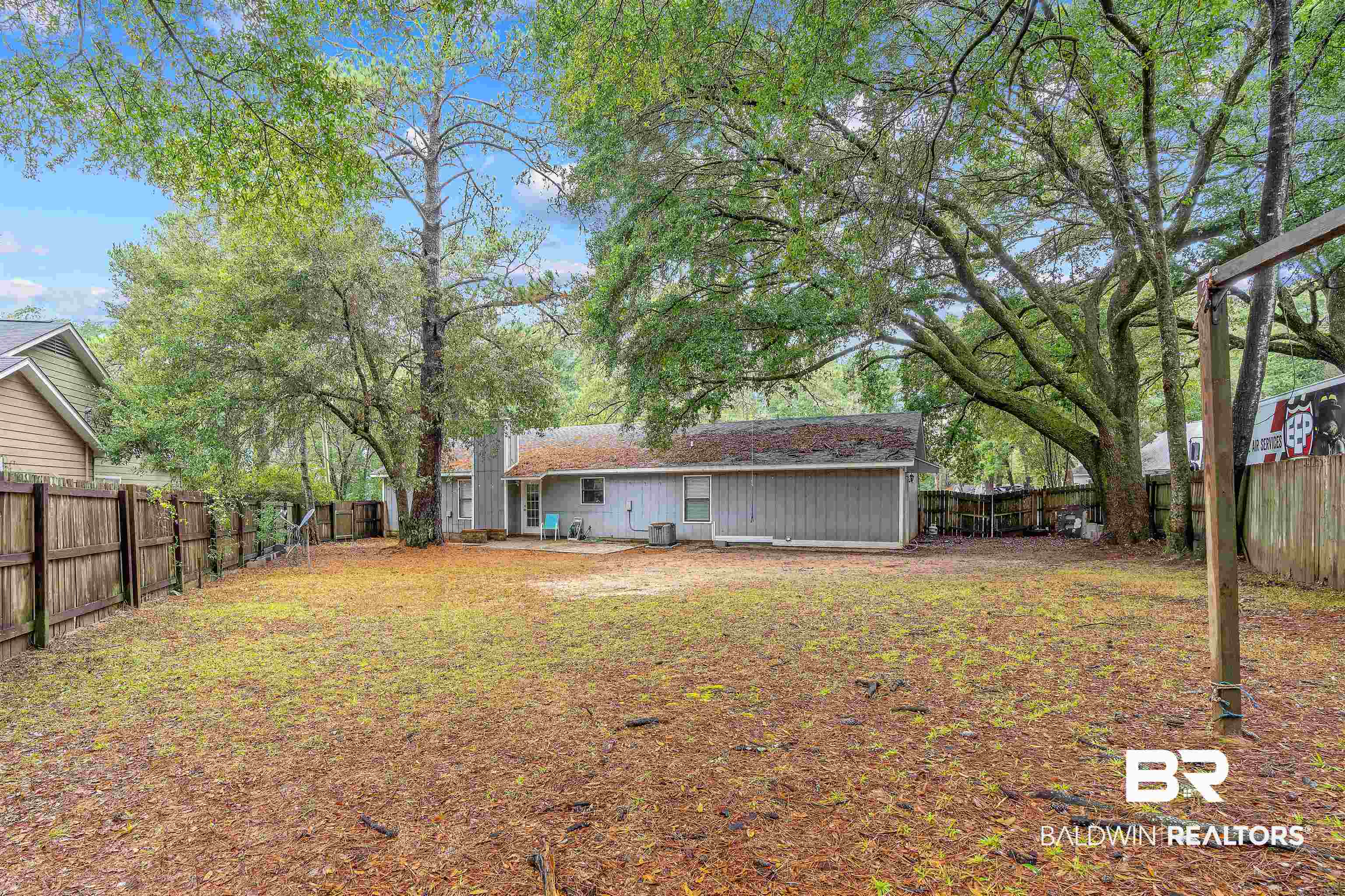 159 Montclair Loop Daphne, AL 36526 - Photo 15 of 18 Back of house featuring a fenced backyard and a patio area
