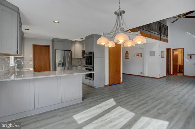 a kitchen with granite countertop a sink stove and cabinets