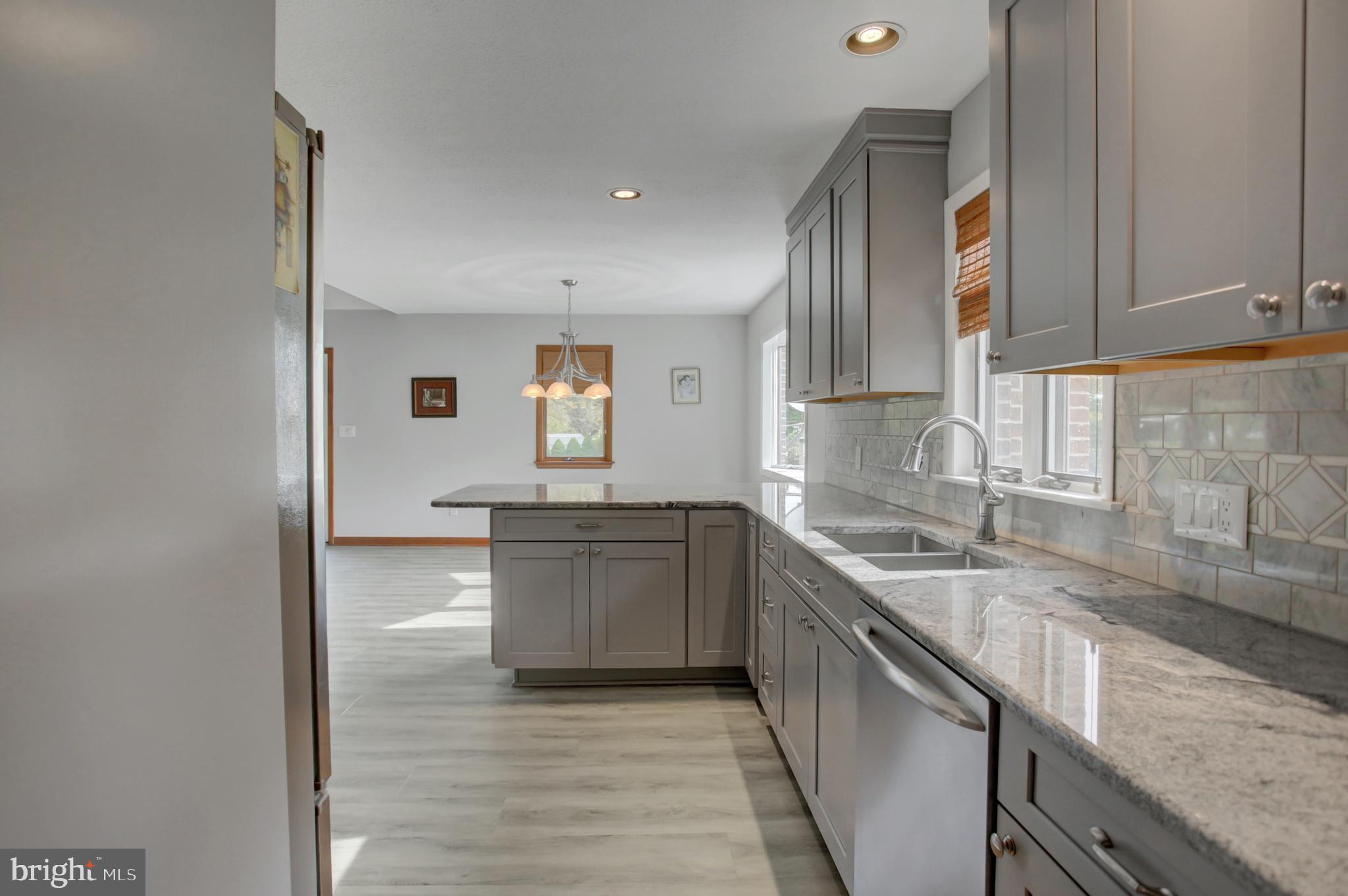 10050 McCreary Road Shippensburg, PA 17257 - Photo 22 of 64 a kitchen with granite countertop a sink stove and cabinets