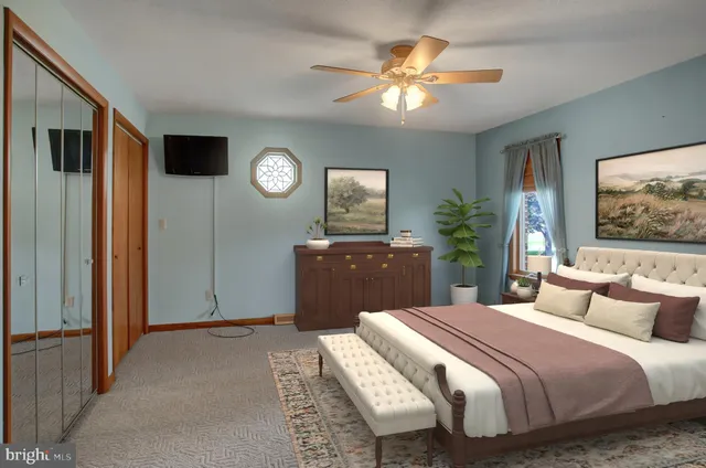 a view of staircase with wooden floor and fan