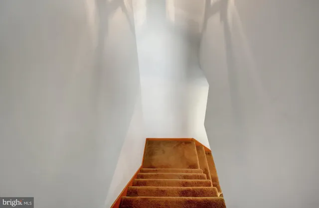 a view of an empty room with a ceiling fan