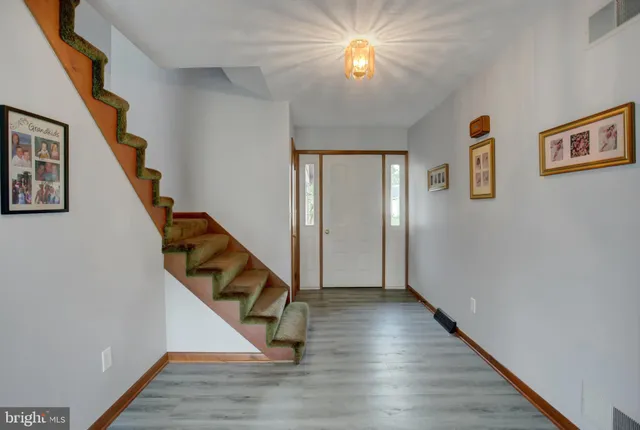 a view of an entryway with wooden floor