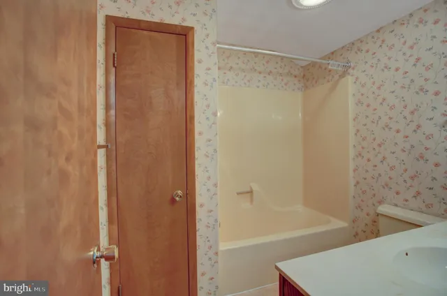 a front view of house with yard and trees