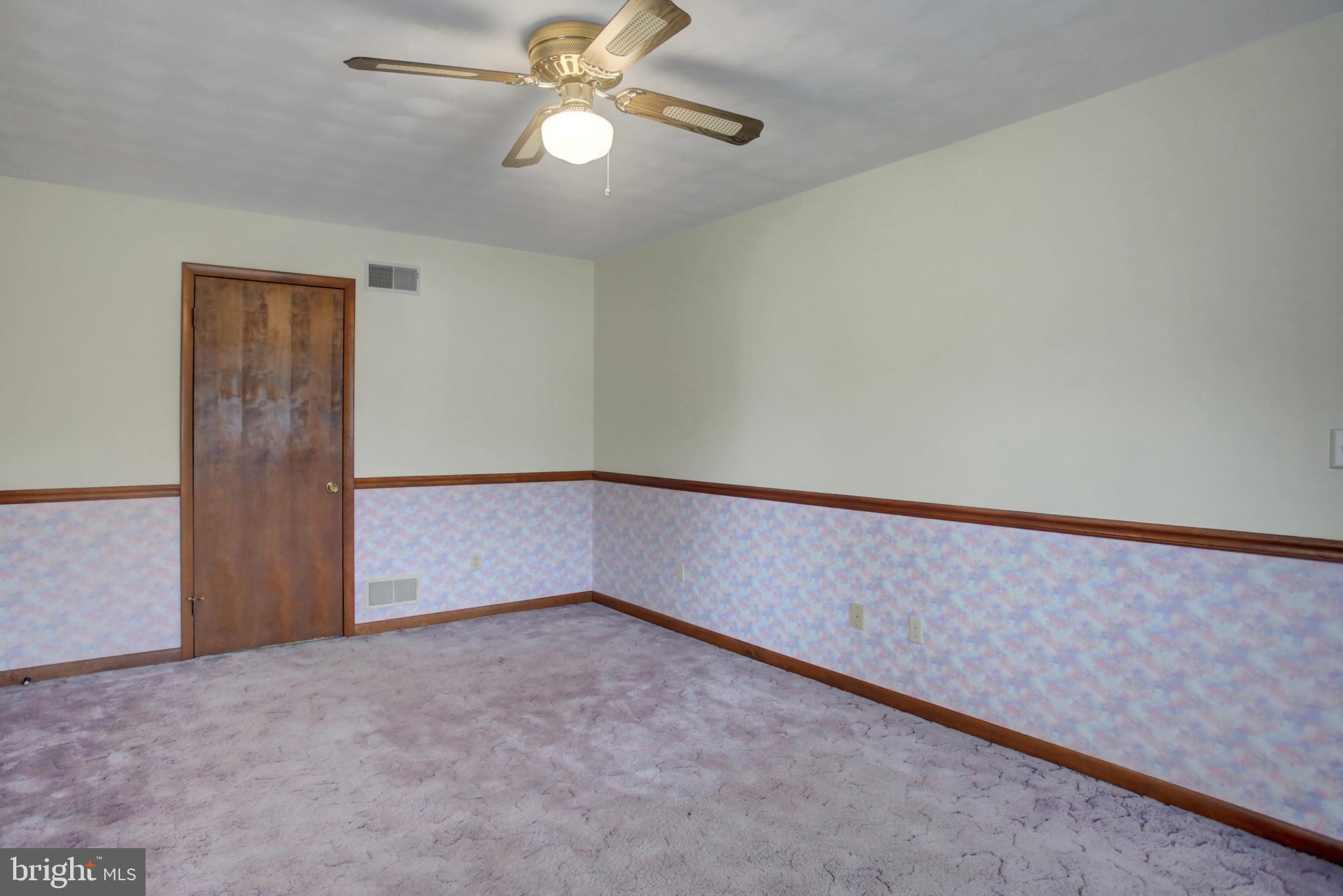 10050 McCreary Road Shippensburg, PA 17257 - Photo 47 of 64 an empty room with a ceiling fan and a window