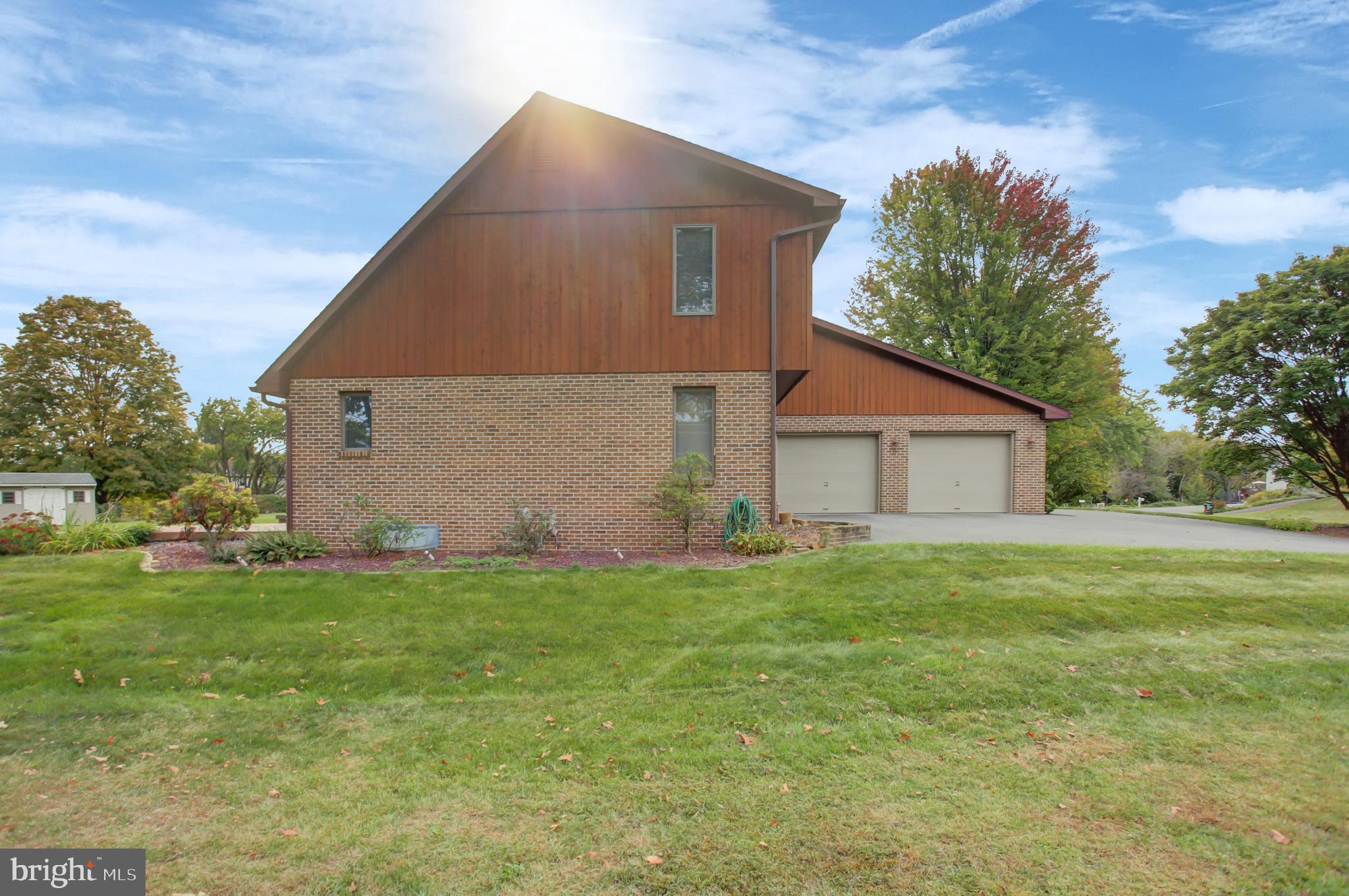 10050 McCreary Road Shippensburg, PA 17257 - Photo 62 of 64 a house that is sitting in the grass with large trees and plants