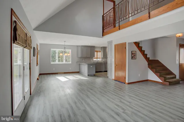 a kitchen with granite countertop a stove a sink and a window