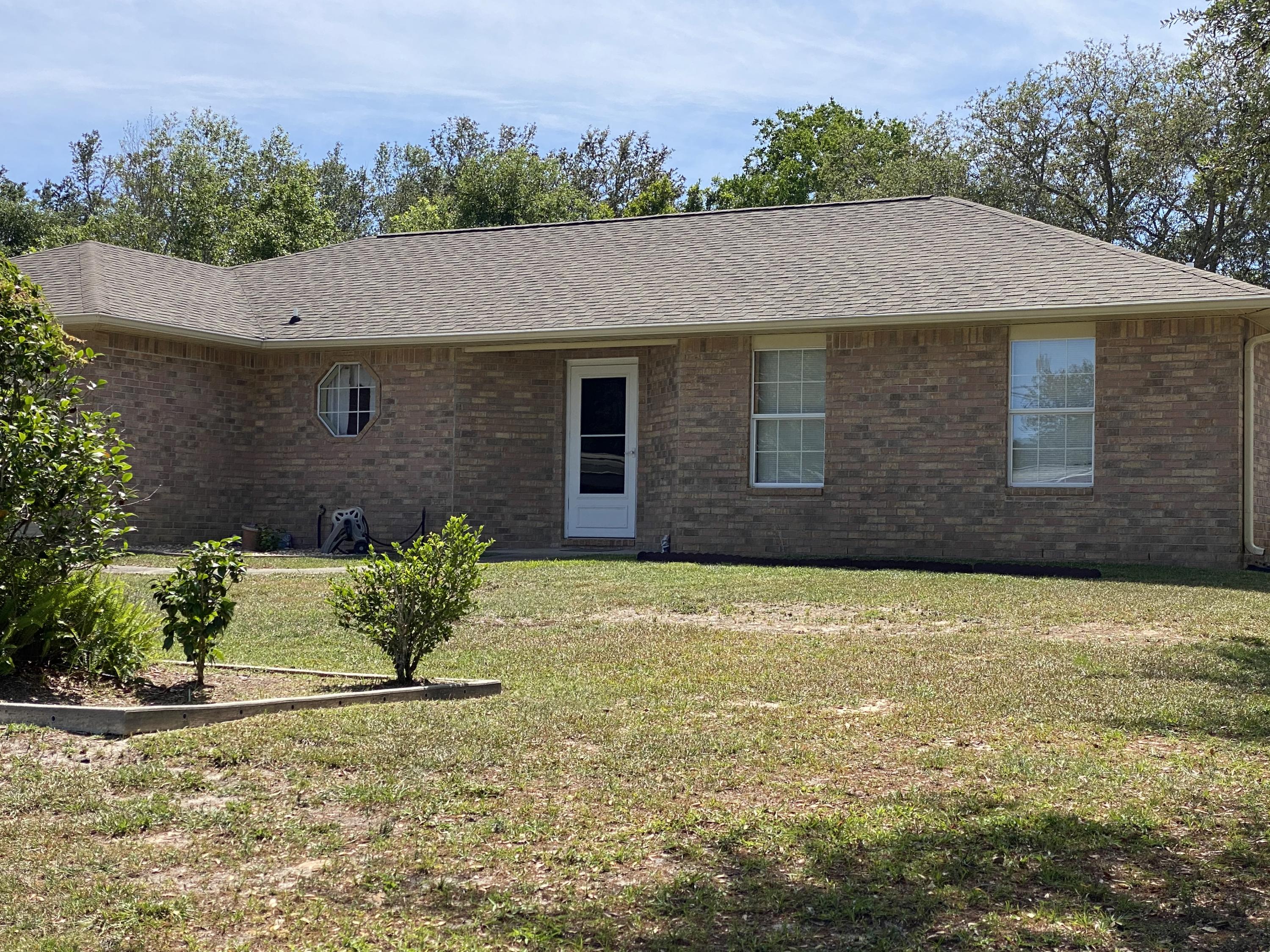 2757 Augustus Road Navarre, FL 32566 - Photo 1 of 1 a house with a garden in front of it