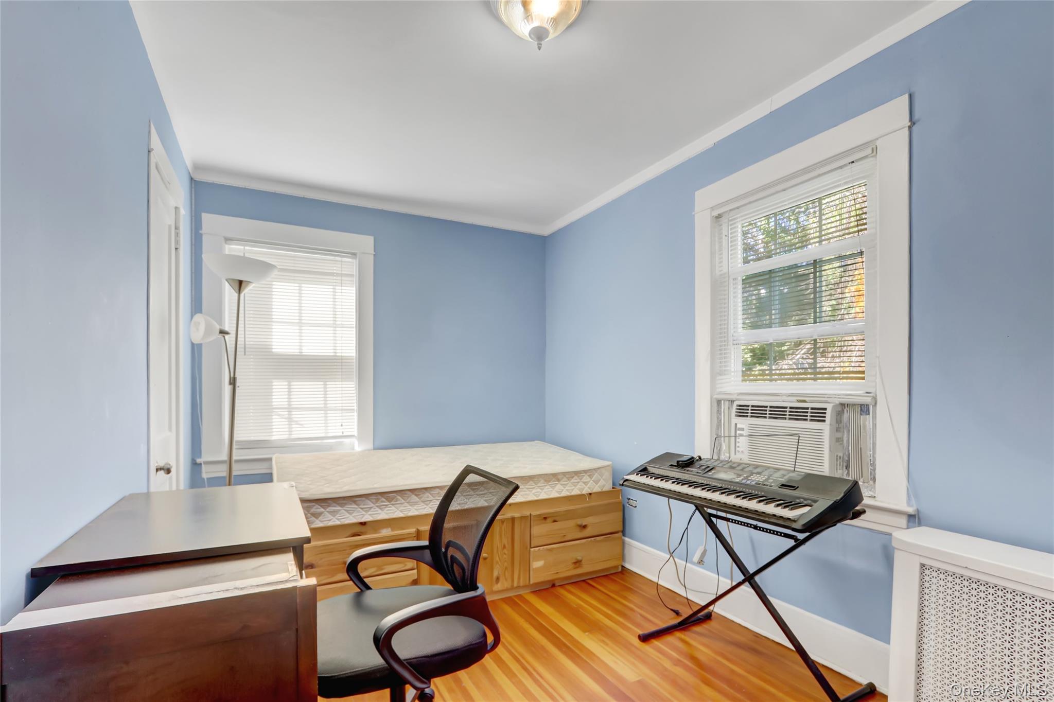 6 Walnut Place Great Neck, NY 11021 - Photo 12 of 19 a bedroom with a bed and a window