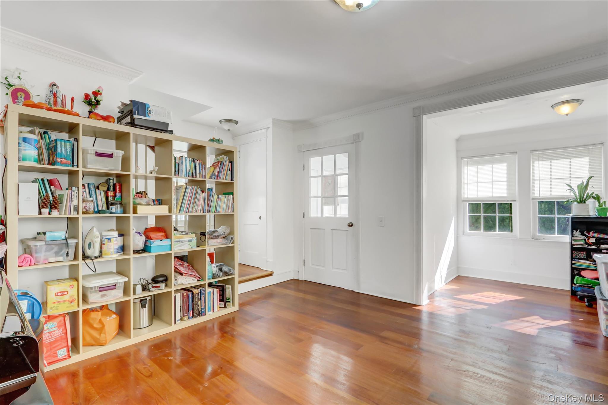 6 Walnut Place Great Neck, NY 11021 - Photo 2 of 19 a living room with lots of furniture and a book shelf