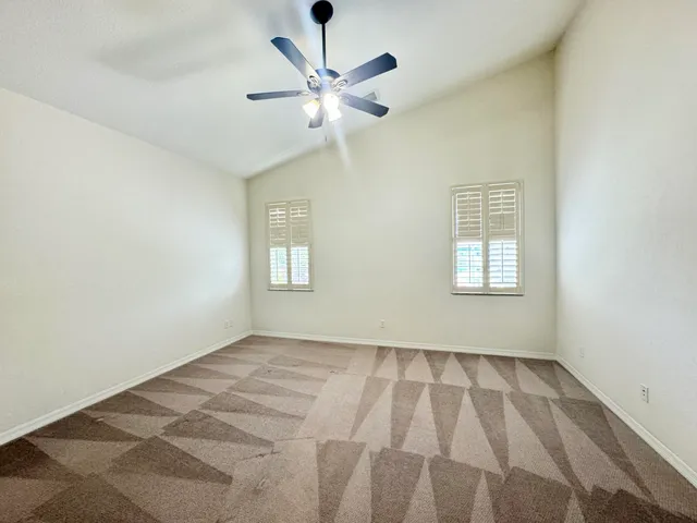 a view of a hallway with wooden floor and a livingroom