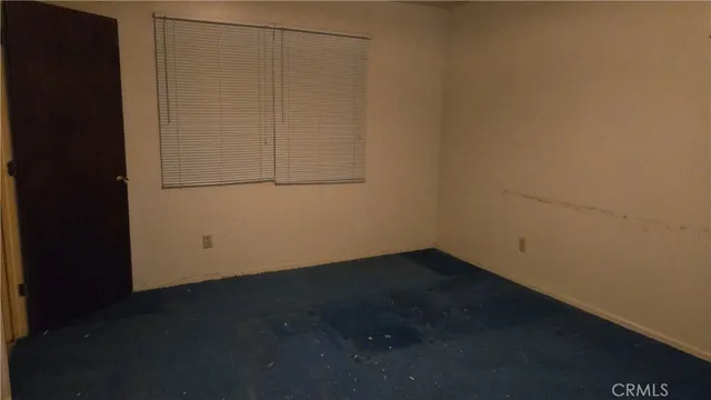 an empty room with wooden floor