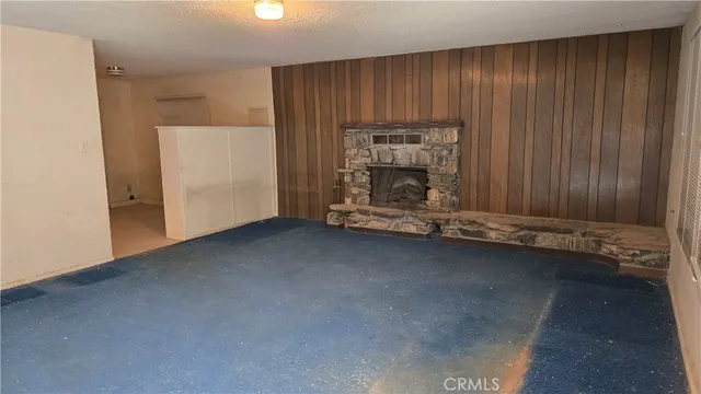 an empty room with a fireplace