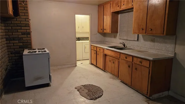 a kitchen with a sink stove and cabinets