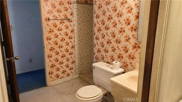 a white toilet sitting next to a shower curtain