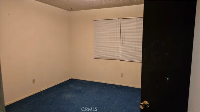 an empty room with wooden floor