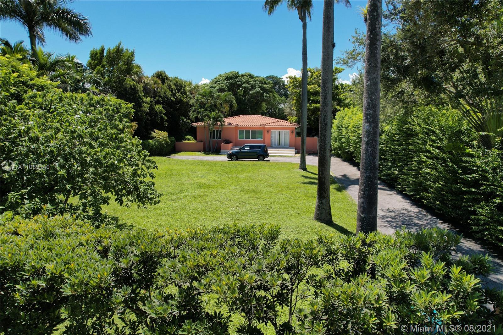 7670 Ponce De Leon Road Miami, FL 33143 - Photo 2 of 6 a garden with trees in front of it