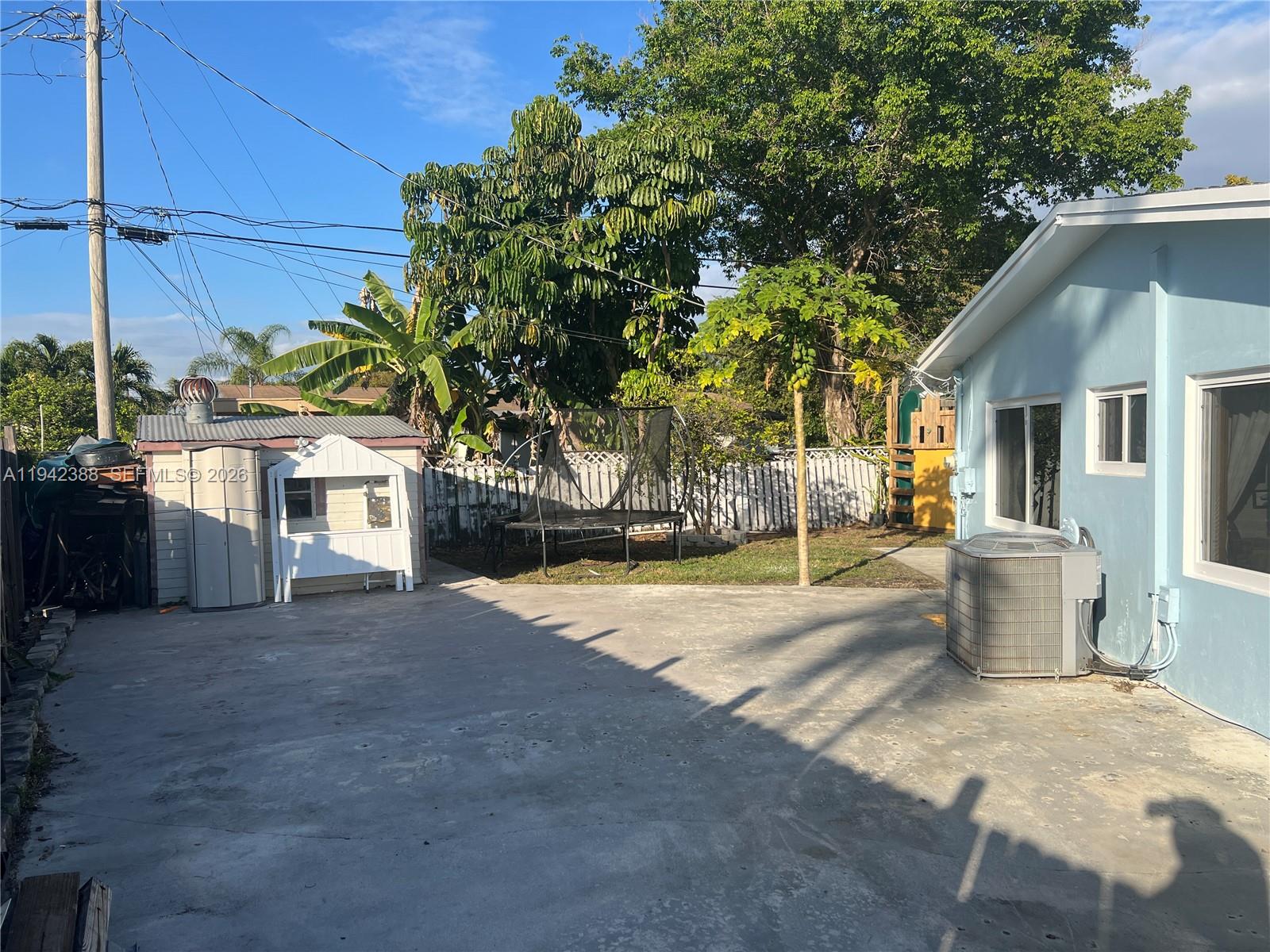 8801 Southwest 42nd Street Miami, FL 33165 - Photo 11 of 75 a view of a house with a patio and a yard