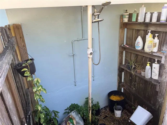 a living room with furniture a flat screen tv and a book shelf