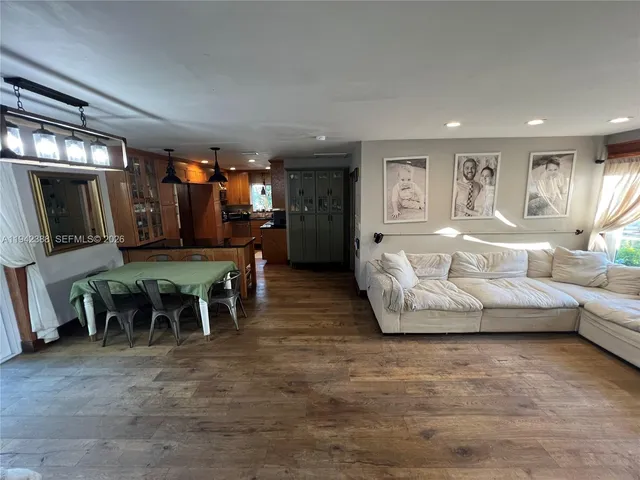 a living room with furniture and a book shelf