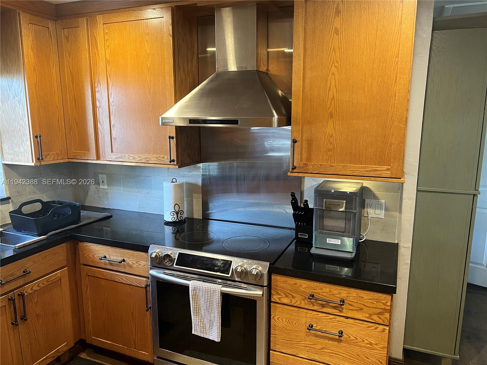 8801 Southwest 42nd Street Miami, FL 33165 - Photo 41 of 75 a kitchen with a stove and a microwave