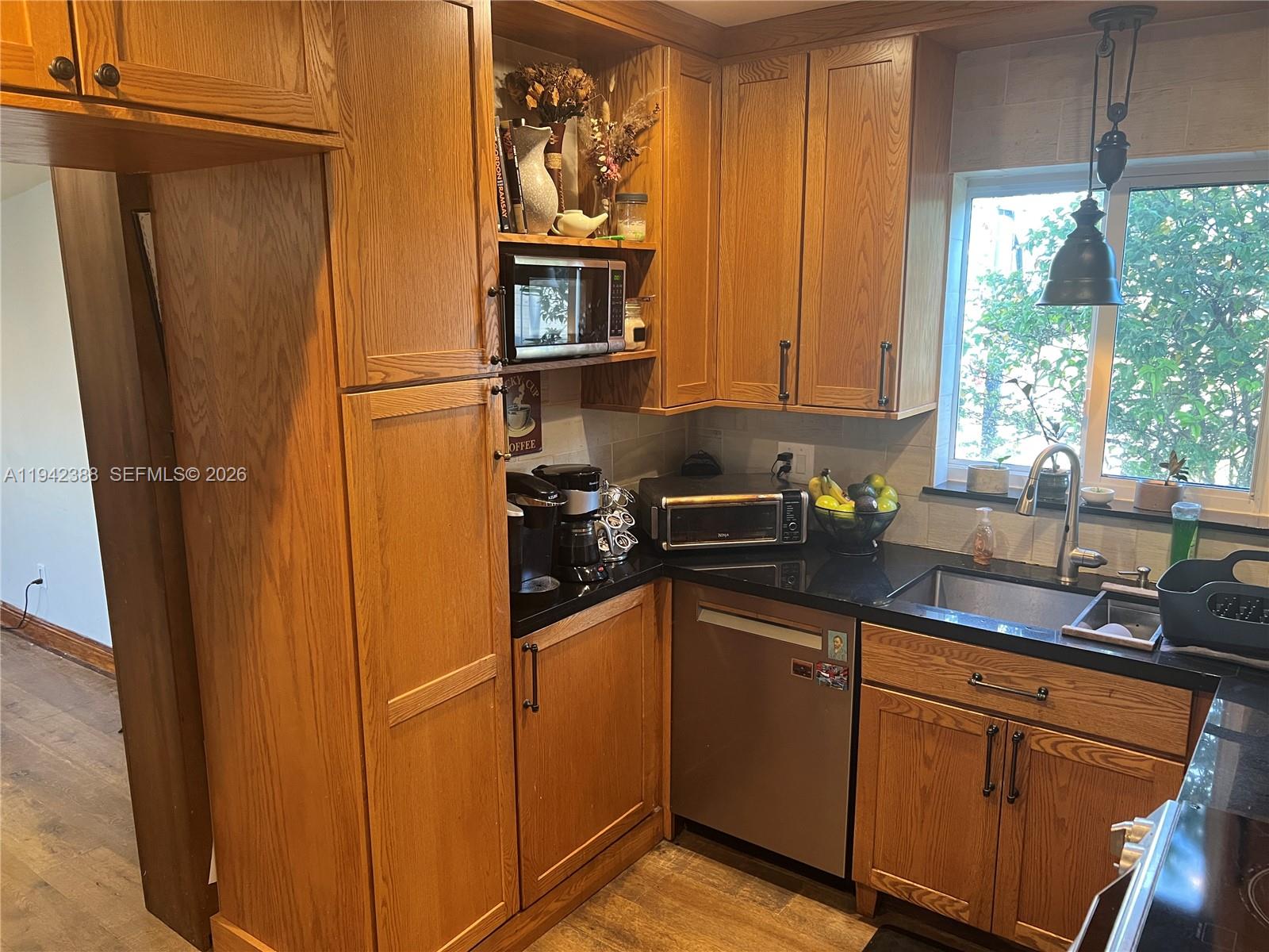 8801 Southwest 42nd Street Miami, FL 33165 - Photo 42 of 75 a kitchen with stainless steel appliances granite countertop a refrigerator and a sink