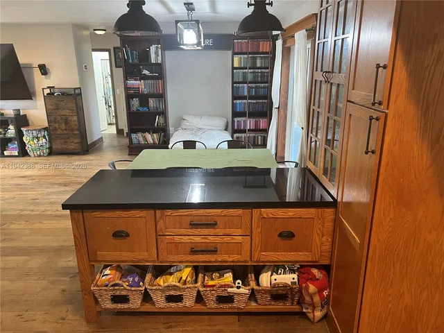 a bathroom with a granite countertop toilet and a window