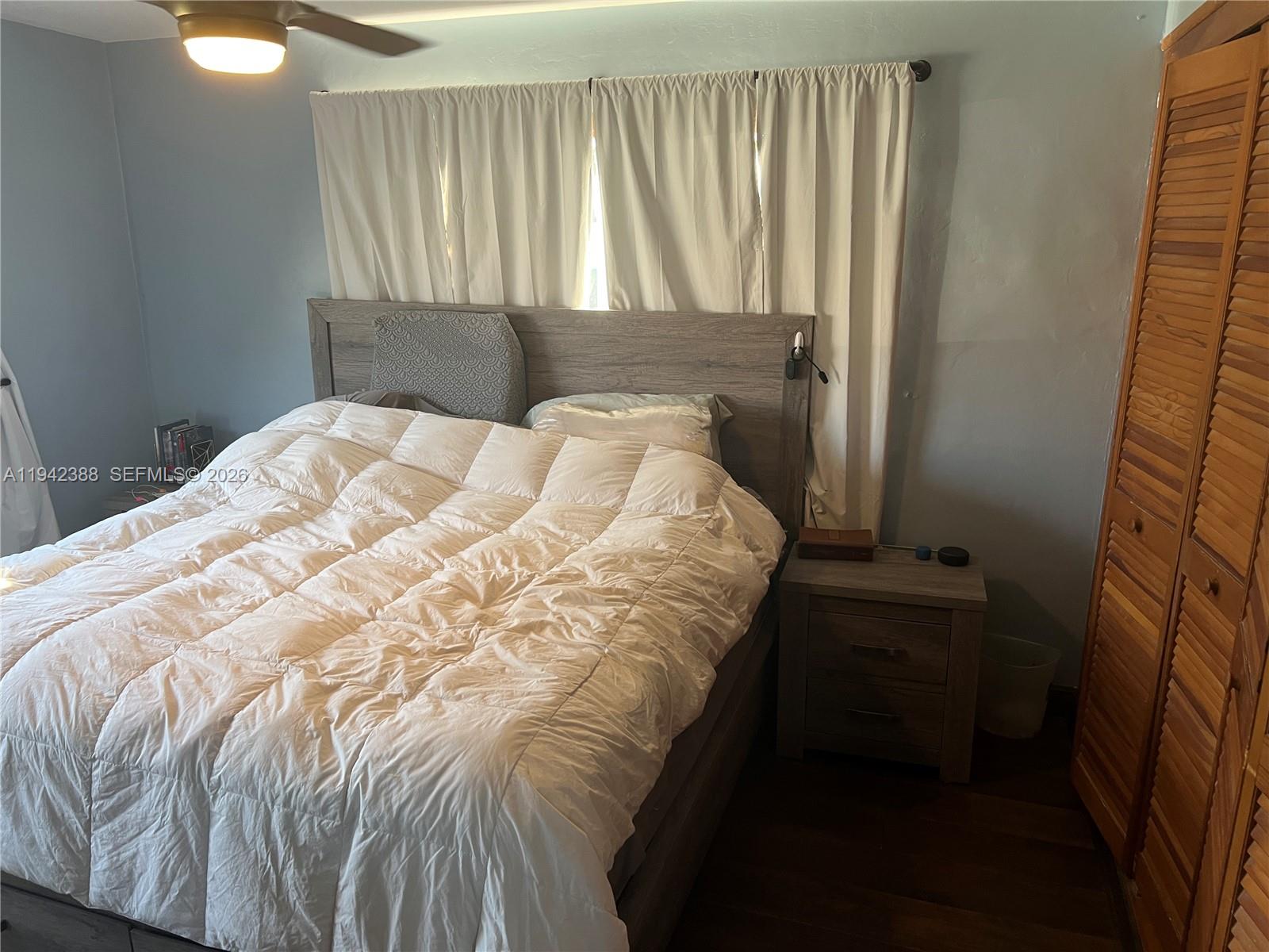 8801 Southwest 42nd Street Miami, FL 33165 - Photo 61 of 75 a bed sitting in a bedroom next to a window