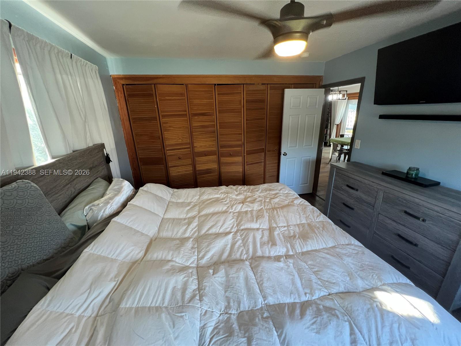 8801 Southwest 42nd Street Miami, FL 33165 - Photo 64 of 75 a bedroom with a bed and a television