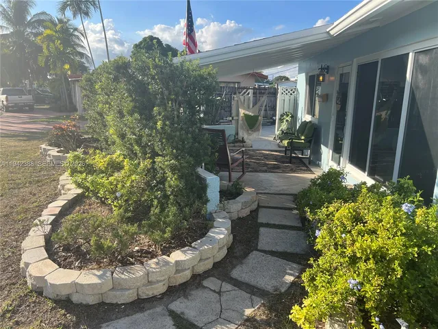 a view of a house with a patio and a yard