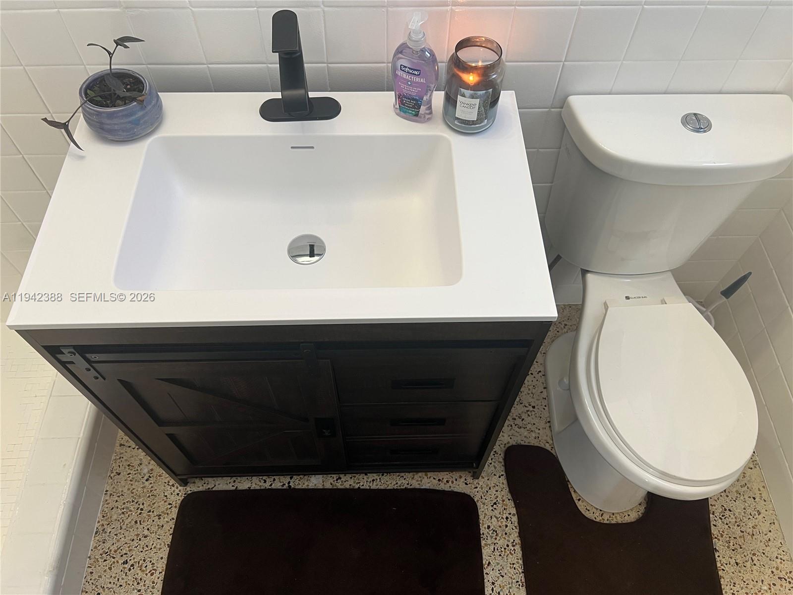 8801 Southwest 42nd Street Miami, FL 33165 - Photo 71 of 75 a bathroom with a toilet and a sink