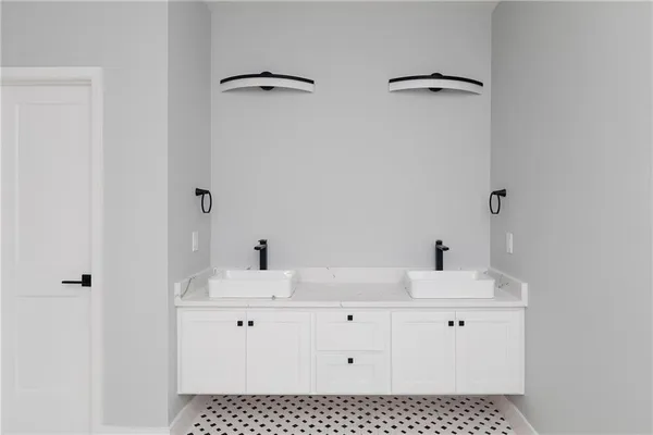 a bathroom with a sink vanity and a mirror