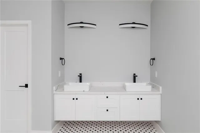 a bathroom with a sink vanity and a mirror