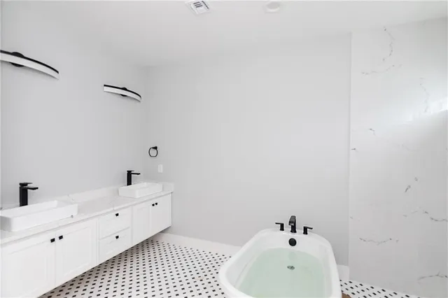 a bathroom with a sink and mirror