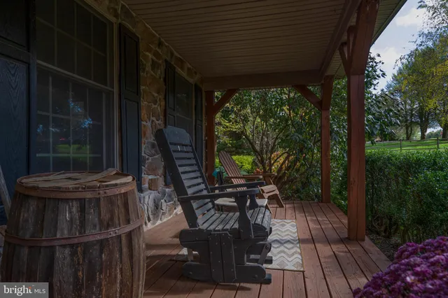 a view of balcony with chairs and wooden fence
