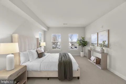 a spacious bedroom with a bed and a couch