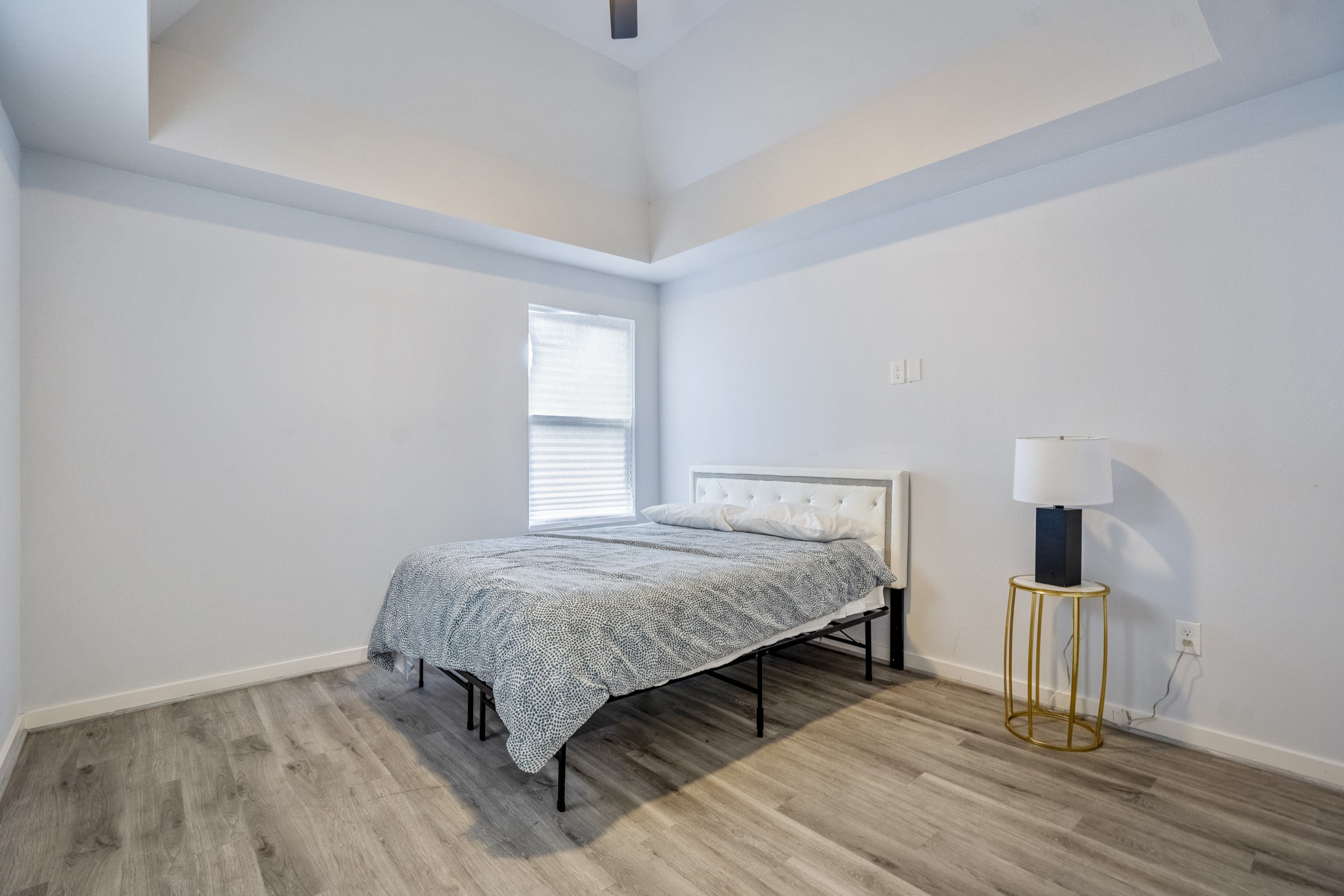 2516 Cleburne Street Houston, TX 77004 - Photo 12 of 23 a bedroom with a bed and wooden floor