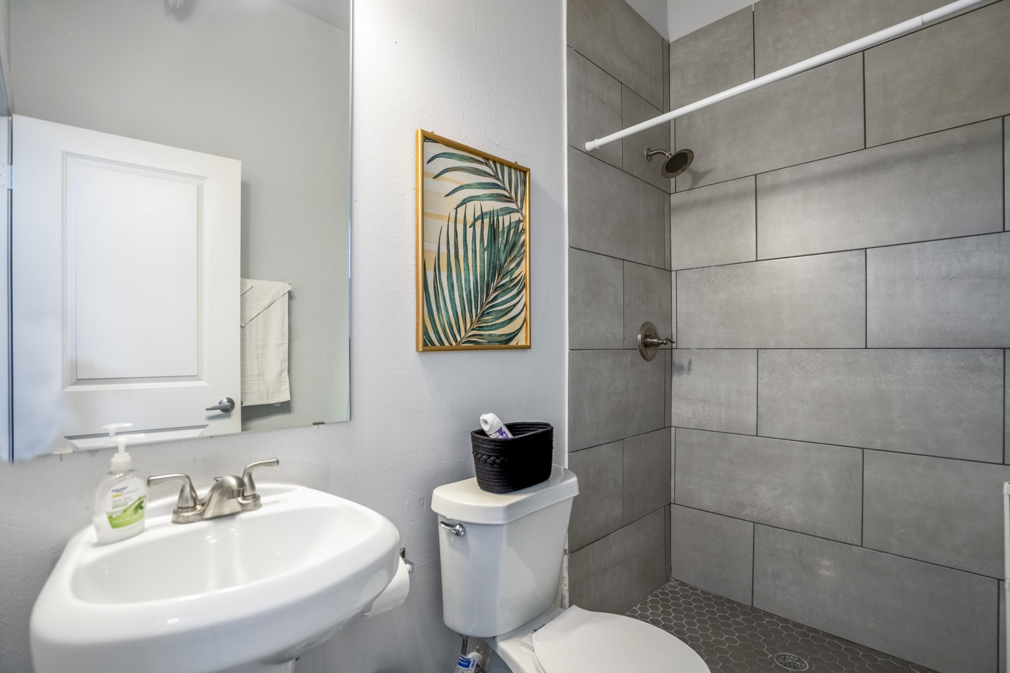 2516 Cleburne Street Houston, TX 77004 - Photo 20 of 23 a bathroom with a sink a toilet and a mirror