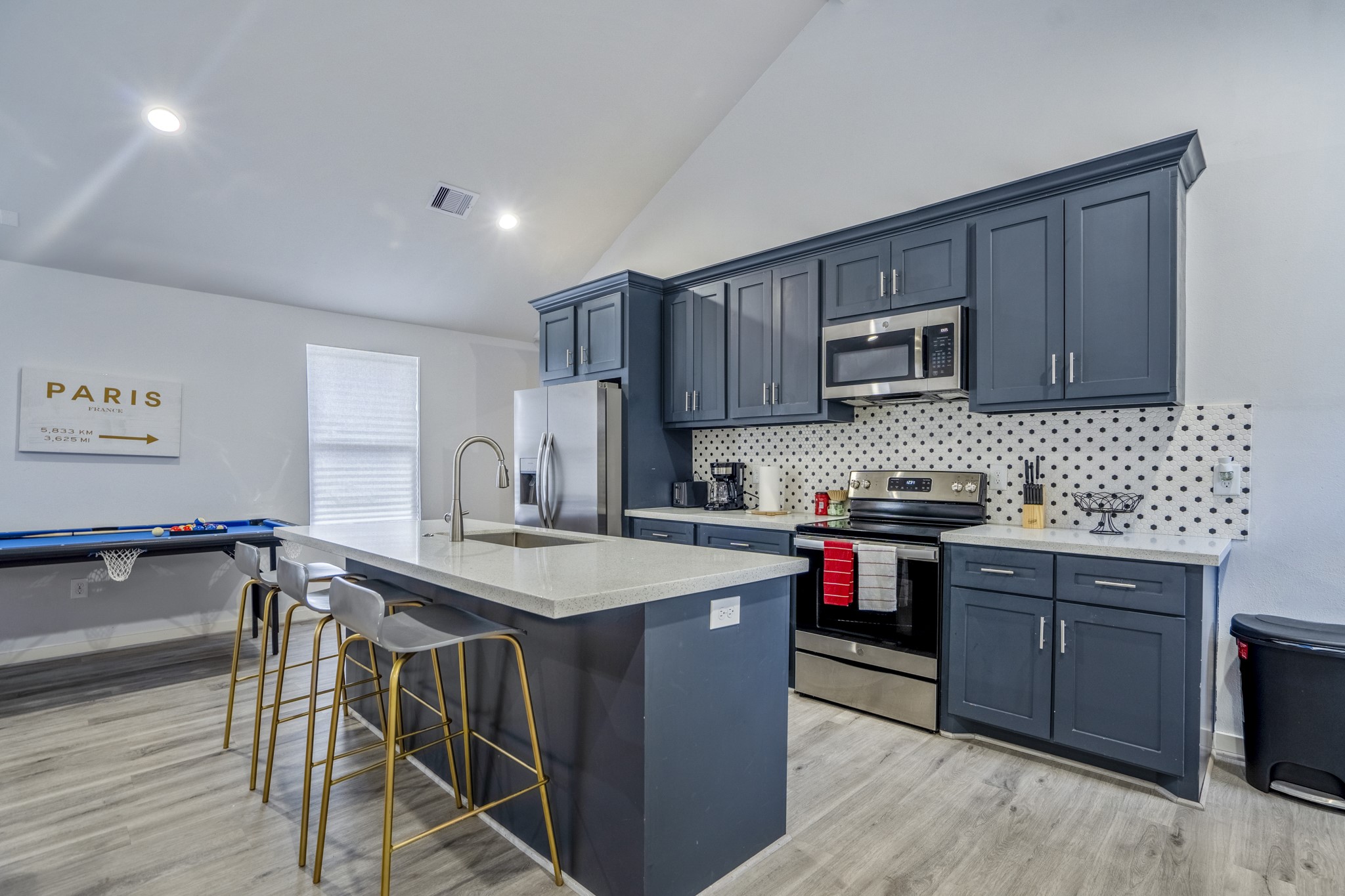 2516 Cleburne Street Houston, TX 77004 - Photo 9 of 23 a kitchen with kitchen island a stove a table and chairs in it