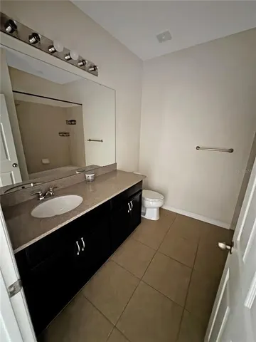 a bathroom with a double vanity sink and mirror