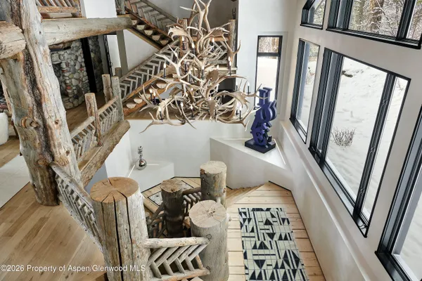 a living room with furniture a fireplace and wooden floor
