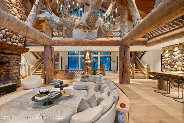 a living room with furniture and a chandelier