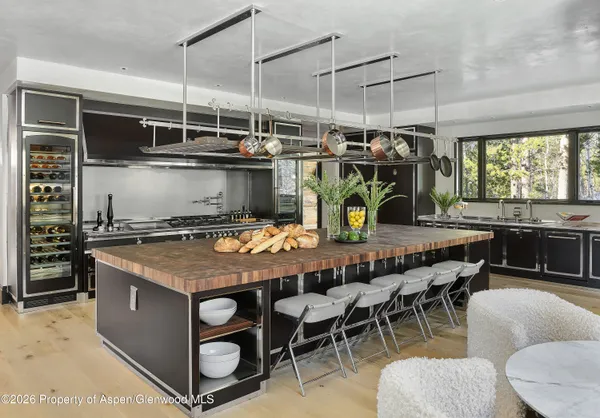 a large white kitchen with a large window