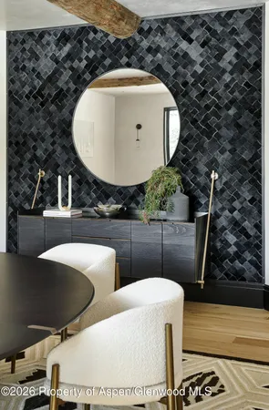 a living room with furniture a rug and a wall painting