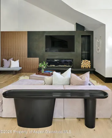 a spacious bedroom with a bed and a flat screen tv