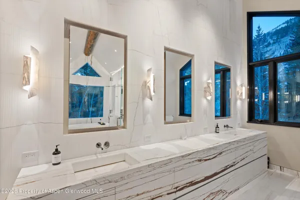 a bedroom with a bed and large window