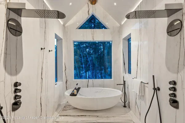 a living room with furniture flat screen tv and kitchen view