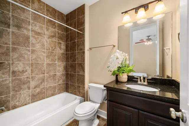 a living room with furniture kitchen view and a chandelier