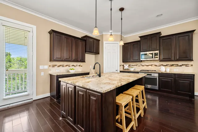 a view of a dining room with furniture a chandelier and wooden floor