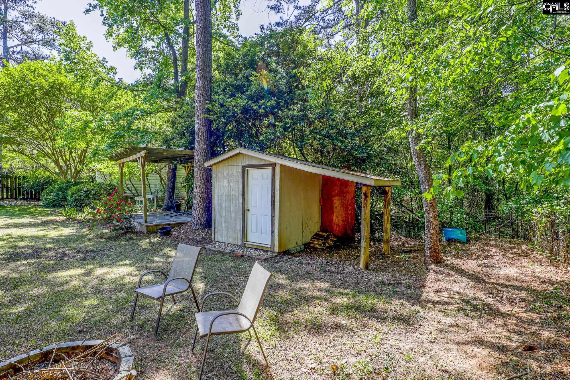 152 Thames Valley Court Irmo, SC 29063 - Photo 31 of 32 a view of backyard with table and chairs and a large tree