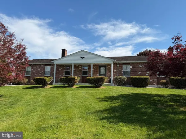 a view of a house with a yard porch and sitting area
